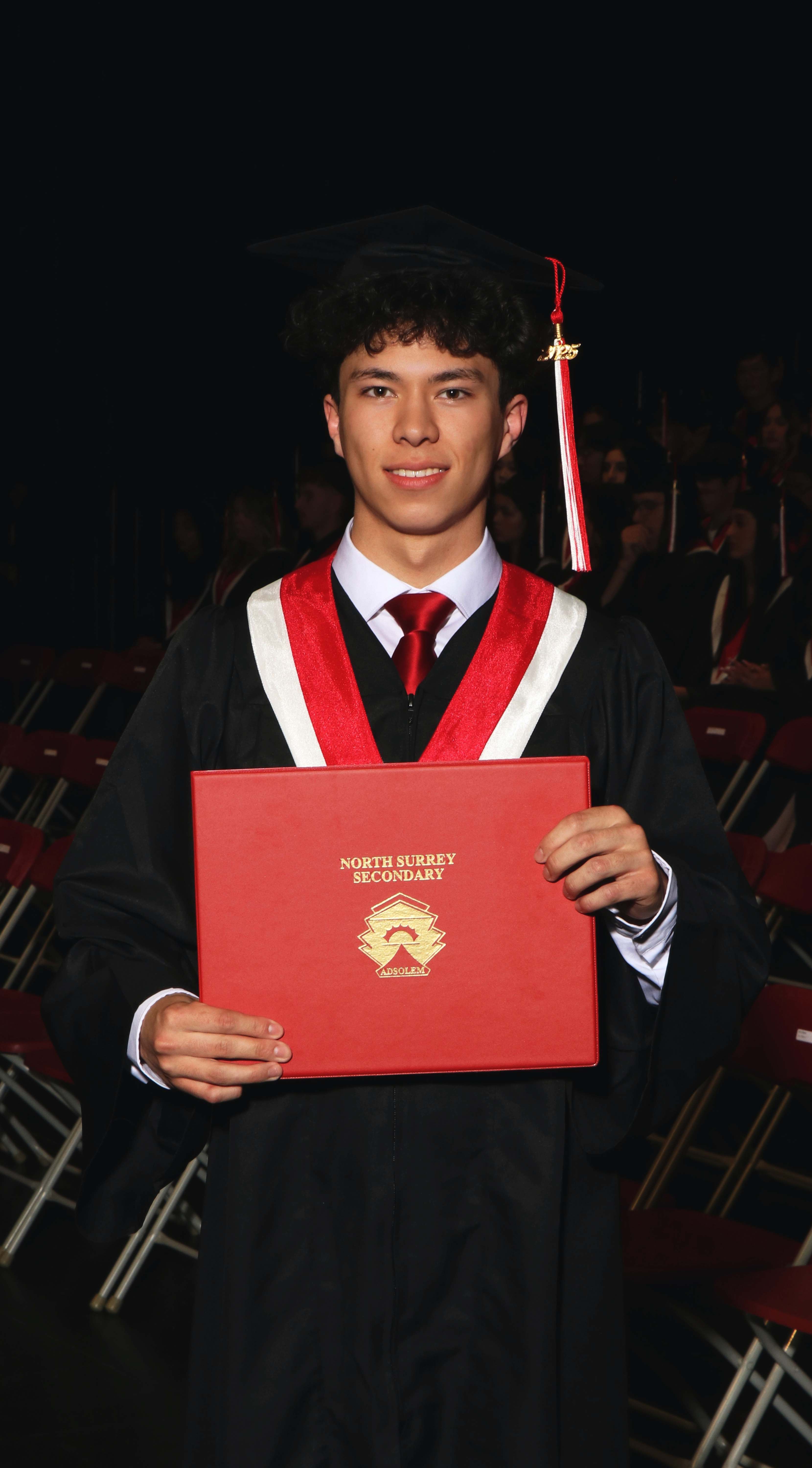 Jason Correia at his North Surrey Secondary graduation, holding his diploma